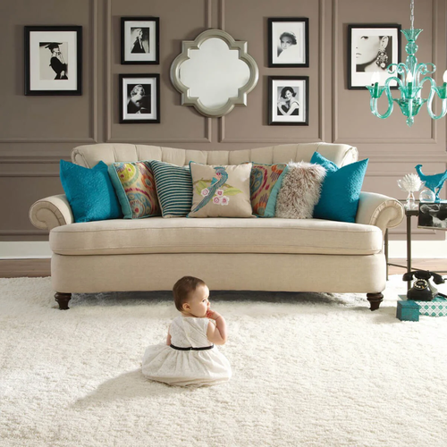 Cute baby sitting on carpet floor | Floorco Flooring