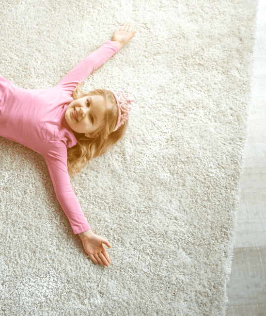 Cute girl laying on rug | Floorco Flooring